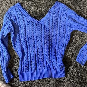 small blue knitted sweater, crossed in the back